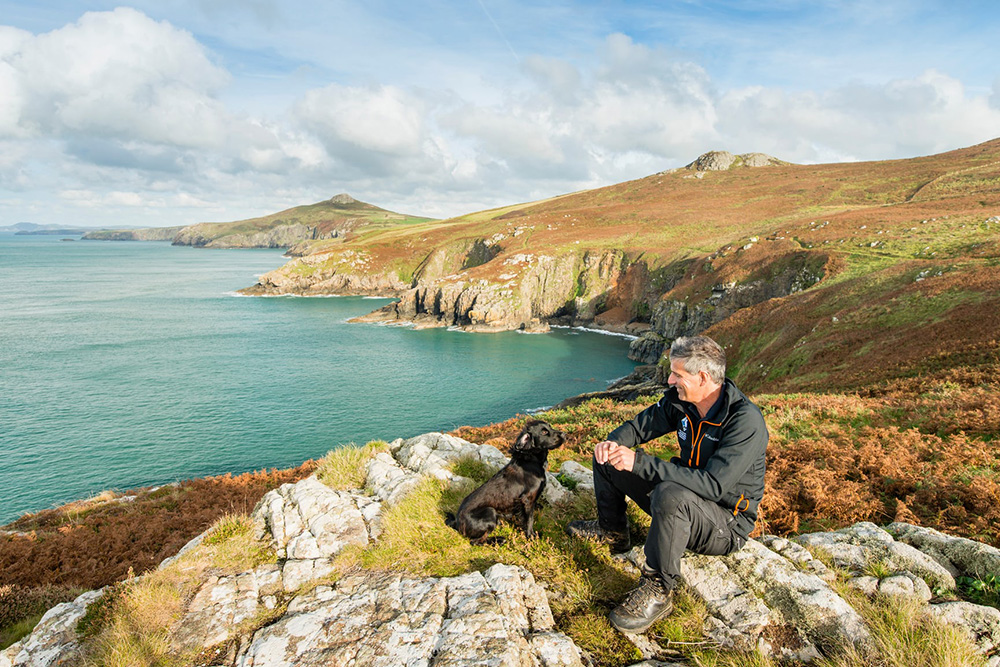 A ranger overlooking a rocky coastline